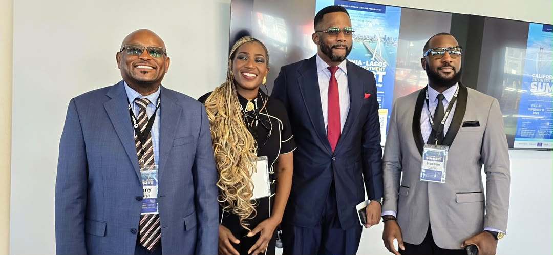 Four colleagues standing together at a formal summit